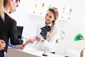 People paying in hotel reception photo