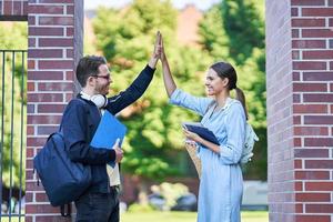 Couple of students in the campus studying outdoors photo