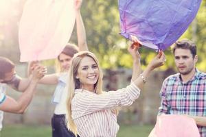 Group of friends floating chinese lanterns photo