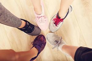 Circle of legs with shoes in a gym photo