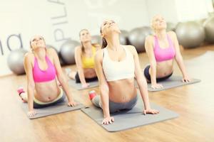 Group of women stretching in gym photo