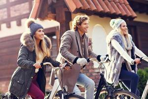 Group of friends on bikes in forest during fall time photo