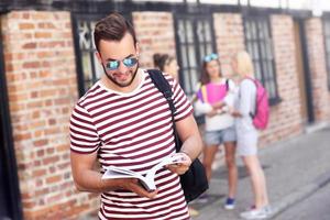 Group of happy students studying outdoors photo