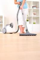 Woman cleaning with vacuum cleaner photo