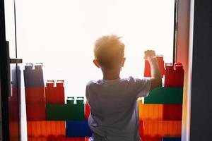 Little boy building a wall at home quarantine during coronavirus pandemic photo