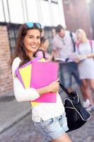 Group of happy students studying outdoors photo