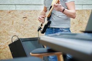 Handsome man playing guitar in studio photo