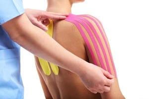 Picture showing special physio tape put on injured back over white background photo
