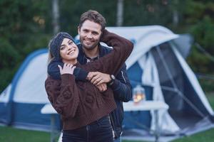 Young nice couple having fun on camping photo