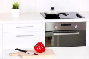 Modern kitchen with red pepper and cutting board photo