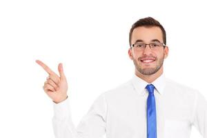 Happy businessman pointing over white background photo