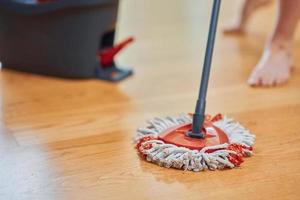 Picture of bucket and mop on the wooden floor