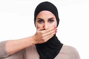 Scared muslim woman over white background photo