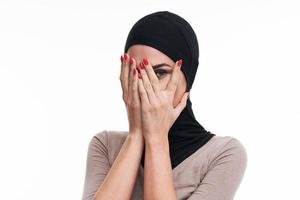Scared muslim woman over white background photo