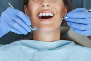 Male dentist and woman in dentist office photo