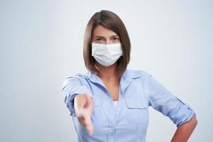 Attractive woman wearing protective mask isolated over white background photo