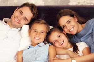 familia feliz relajándose en la habitación del hotel foto