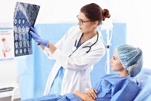 Female doctor taking care of patient in hospital photo