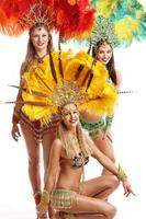 Brazilian women dancing samba over white background photo