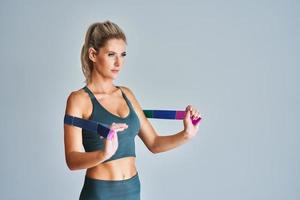 Adult woman working out with stretching belt photo