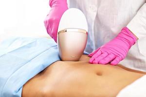 Adult woman having laser hair removal in professional beauty salon photo