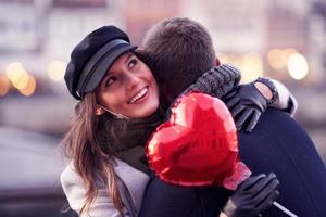 Happy couple celebrating Valentines Day in masks during covid-19 pandemic photo