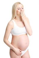 Pregnant woman posing over white background photo