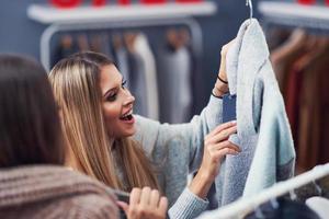 Adult women shopping for clothes in boutique in autumn photo
