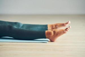 Adult woman practising yoga at home photo