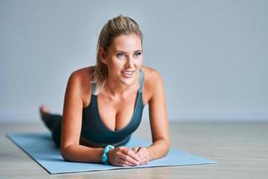 Adult woman practising yoga at home photo