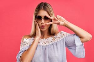 Beautiful adult woman posing over pink background photo