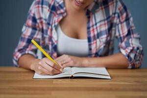 Midsection of female student learning at home photo