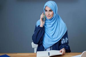 Muslim adult woman using smartphone photo