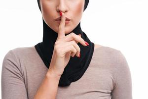 Scared muslim woman over white background photo