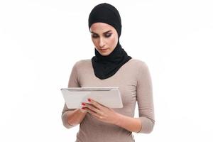 Muslim woman using tablet over white background photo