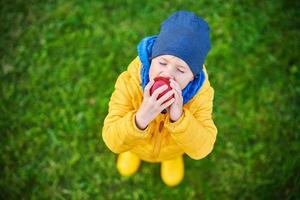 Happy child boy playing outside in autumn photo
