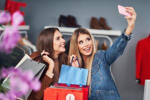 Adult women shopping for clothes in boutique in autumn photo