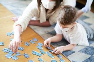 Mother and child playing together at home isolation duringcoronavirus pandemic photo