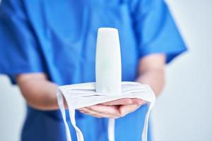 Close up portrait of female medical doctor showing antiseptic sanitizer photo