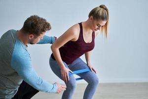 Adult woman training with her personal trainer photo