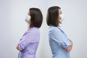 Attractive woman wearing protective mask isolated over white background photo