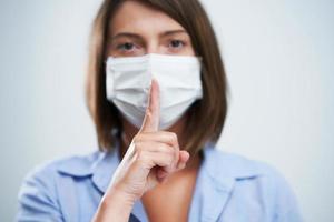 Attractive woman wearing protective mask isolated over white background photo