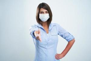 Attractive woman wearing protective mask isolated over white background photo