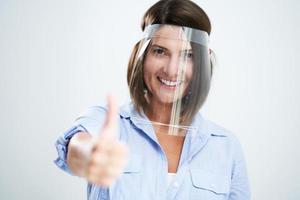 Attractive woman wearing protective shield isolated over white background photo