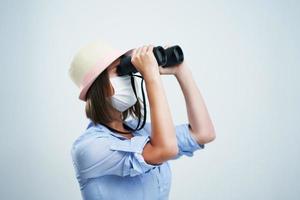 Woman tourist wearing protective mask isolated over white background photo