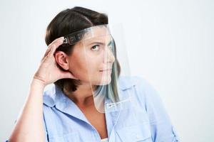 Attractive woman wearing protective shield isolated over white background photo