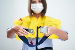 Stewardess wearing protective mask isolated over white background photo