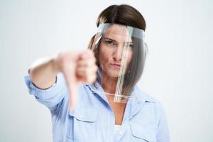 Attractive woman wearing protective shield isolated over white background photo