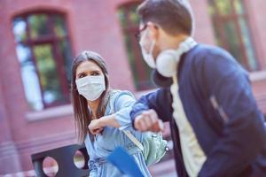 Couple of students in the campus wearing masks due to coronavirus pandemic photo