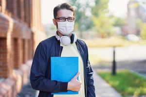 Male student in the campus wearing maskk due to coronavirus pandemic photo